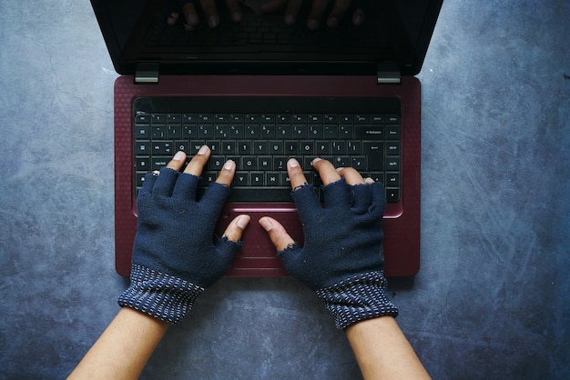 A close-up of a hand hovering over a laptop keyboard, about to click on a suspicious link in an email, highlighting the danger of phishing scams.