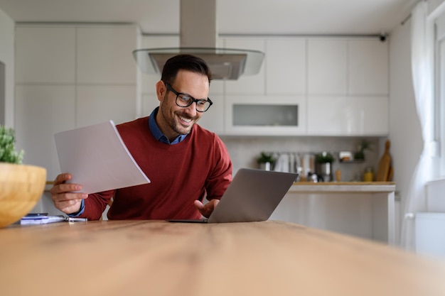 A person smiling while using a laptop, showcasing how they are claiming tax credits online. The scene is set in a comfortable home office.