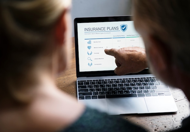 An employee reviewing their benefits enrollment form on a laptop, with a focus on the section detailing the Dependent Care FSA contributions and terms.