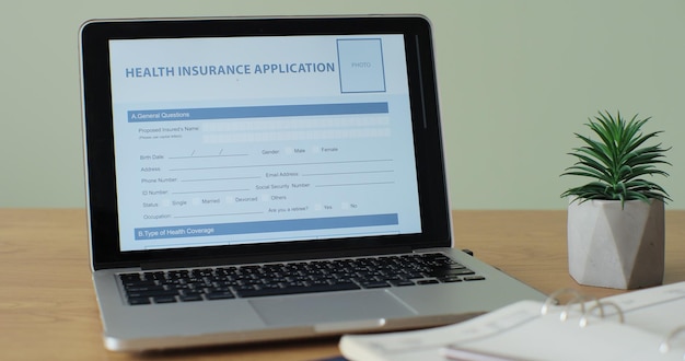 A close-up shot of an employee benefits enrollment form, highlighting the section on life insurance options and coverage amounts with a pen resting on the form.
