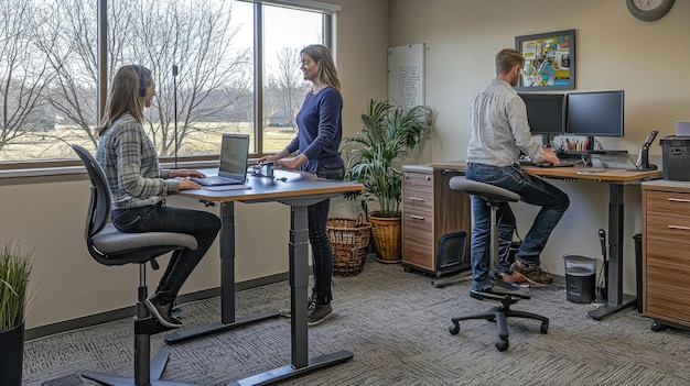 An office environment where employees are using standing desks and ergonomic chairs. Natural light is abundant, creating a comfortable and healthy workspace. Some employees are stretching at their desks.