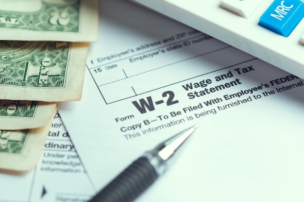 A close-up of a W-2 form highlighting the sections for taxable income and deductions.