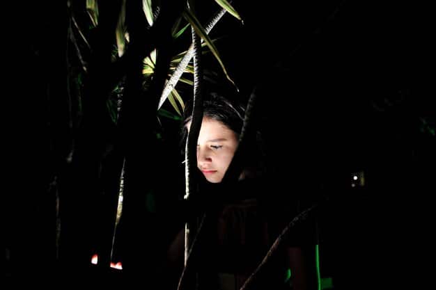 A dimly lit scene from a Korean thriller, showing a character with a determined expression amidst a chaotic environment. The atmosphere is tense and mysterious.
