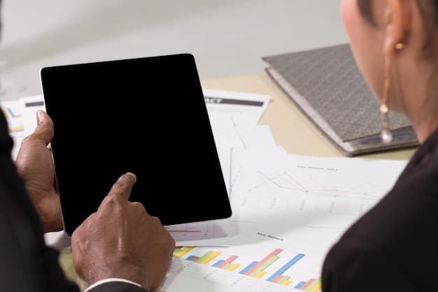 Close-up shot of a producer reviewing a script on a tablet, with financial spreadsheets visible in the background. The setting is a modern office.