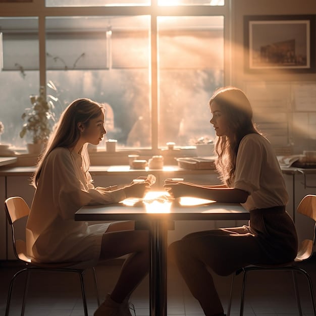 A scene showing two women sitting across from each other at a table, engaged in a tense conversation. The lighting is dramatic, highlighting their faces and expressions.