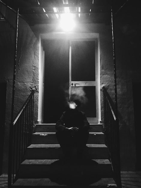 A black and white still from the movie showing Johann Radmann intensely questioning a suspect in a dimly lit room, emphasizing the tension and gravity of the investigation.