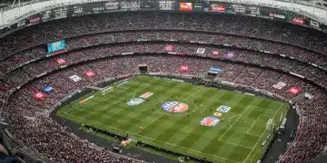 Dynamic sports stadium with prominent sponsor logos during a major event, showcasing brand visibility and financial impact.